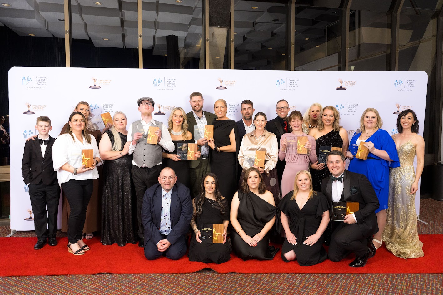 Award winners from the Tasmanian Disability Awards gathered on the red carpet with their trophies